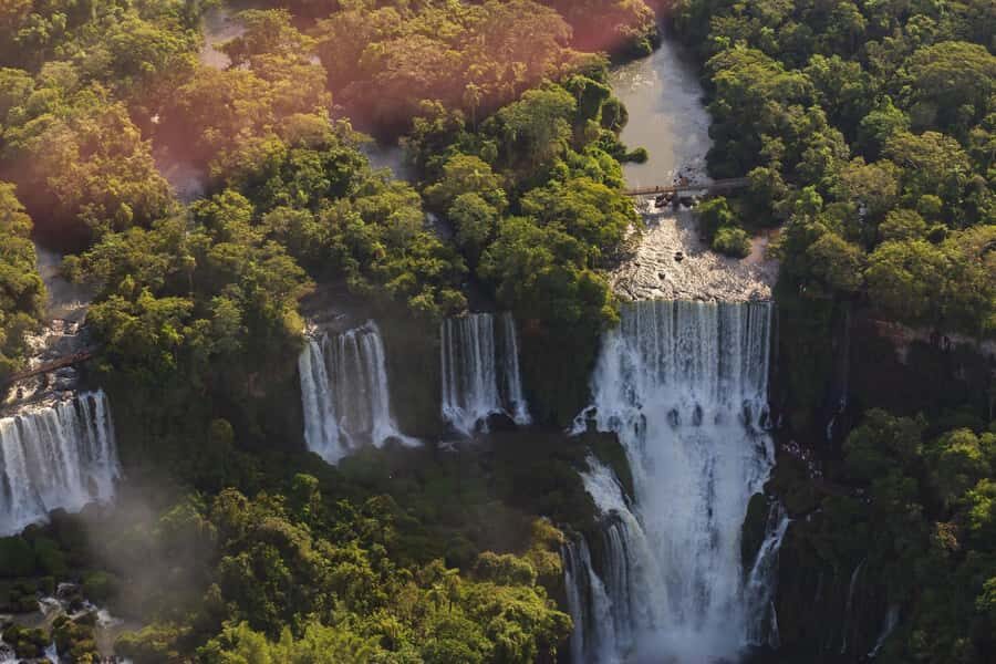 Puerto Iguazu: Iguazu Falls Boat Tour and Gran Aventura - The 1-kilometer above-river walkway: calm water before the thunder